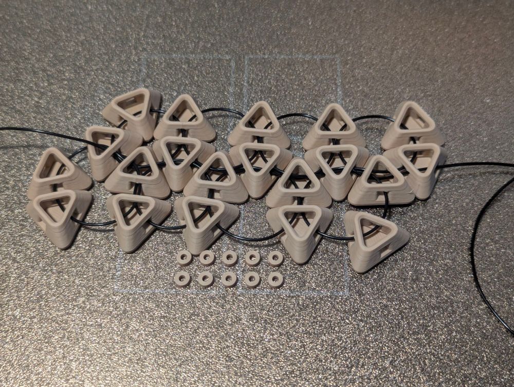 3d printed pieces with elastic thread stringing them together.
