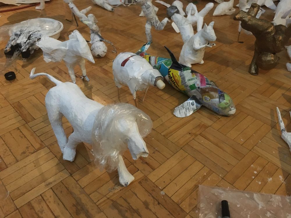 Some work in progress sculptures on a hard wood floor