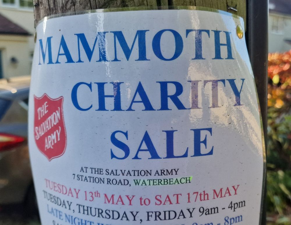 Flyer on a telegraph pole advertising a Mammoth Charity Sale
