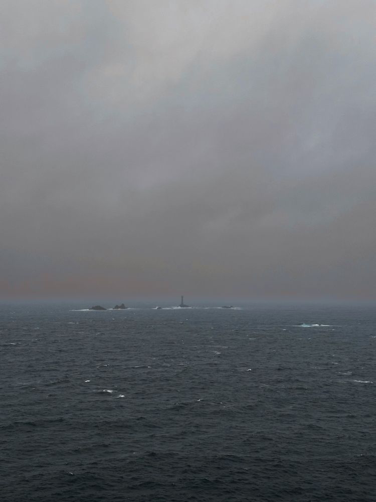 Dark morning skies, a choppy sea and Longships Lighthouse