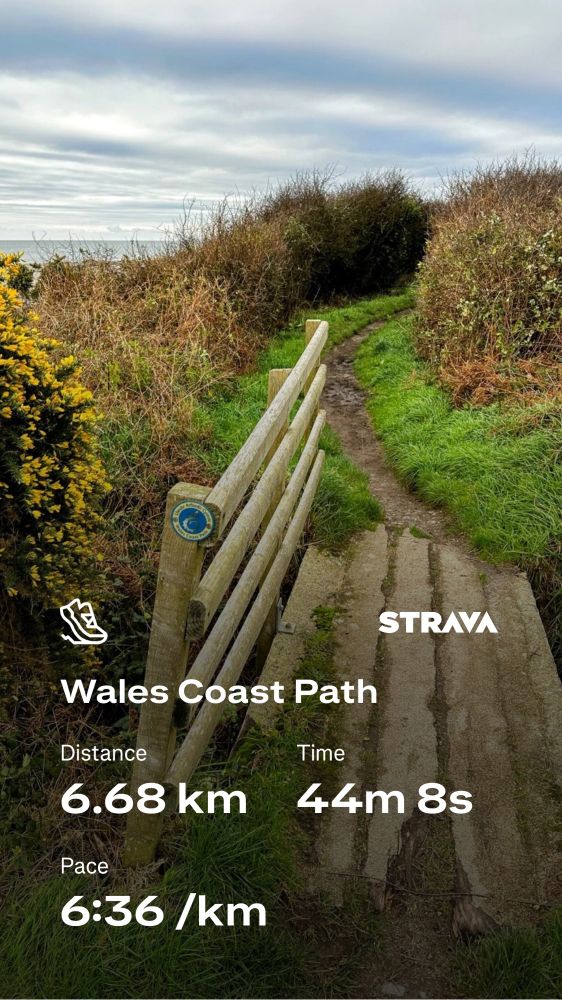 Strava running stats against a photo of the Wales Coast Path trail.