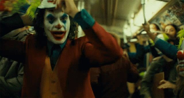 header image - a man in a clown costume is holding a baseball cap