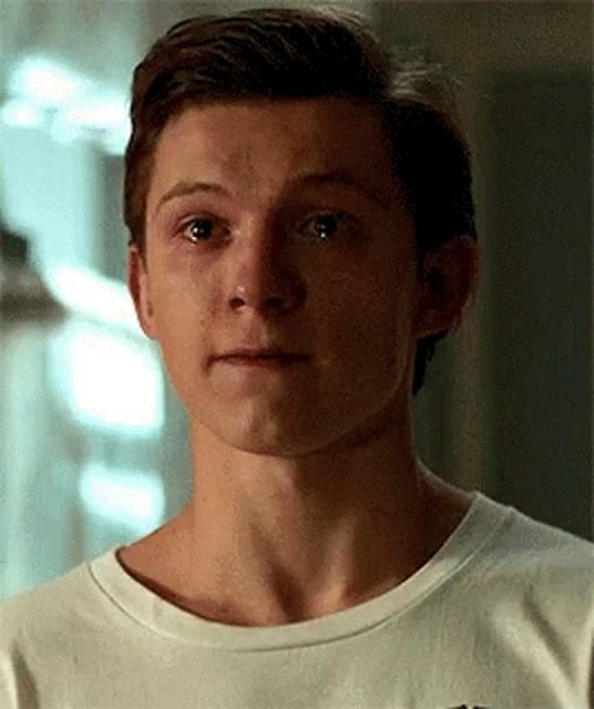 header image - a close up of a man 's face wearing a white t-shirt .