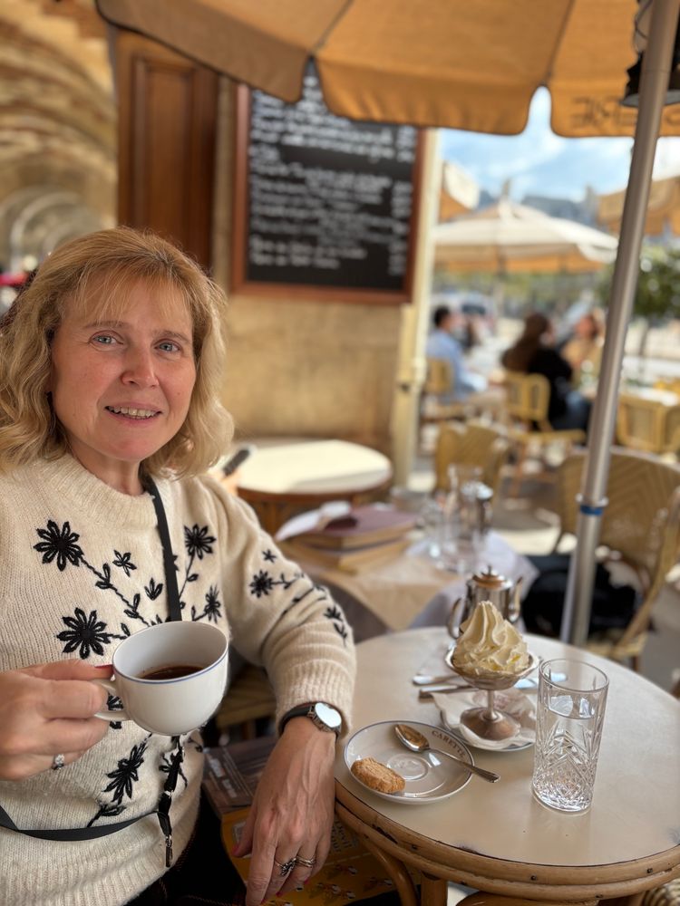 Woman with cup of chocolate at an outdoor table