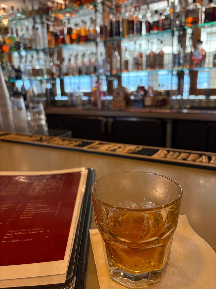 Glass of bourbon on a bar counter 