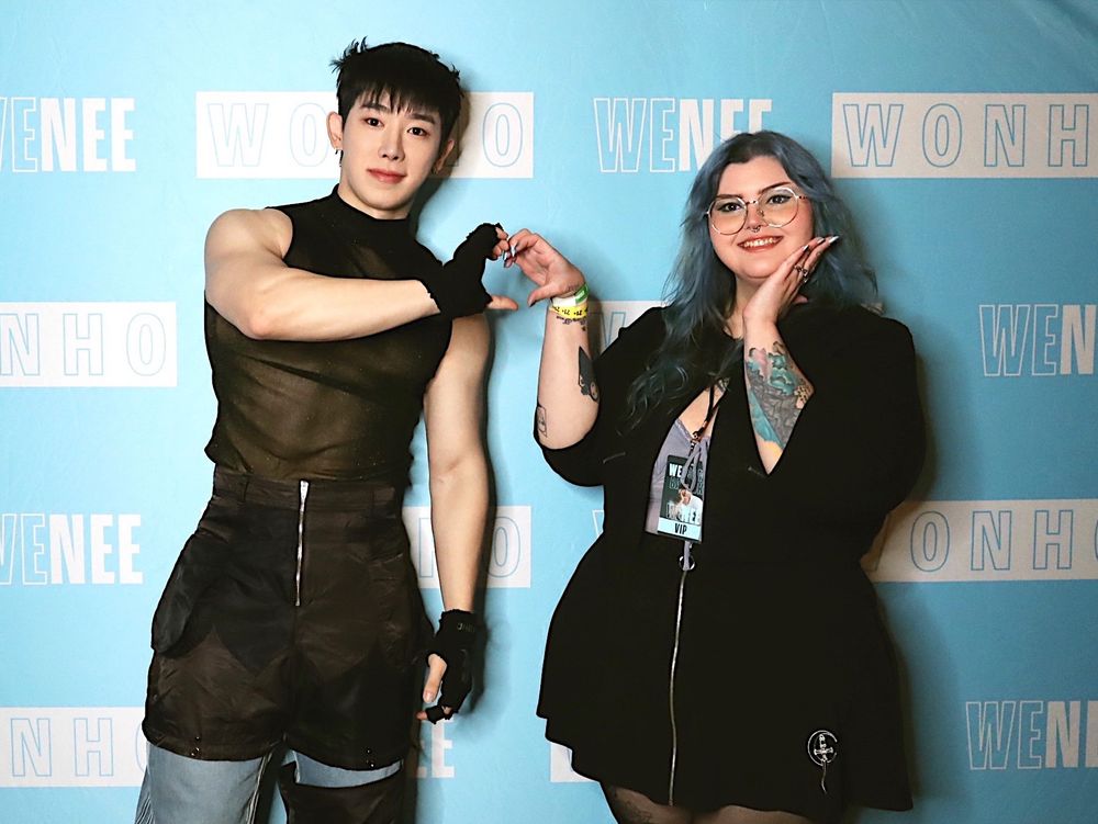 a photo of wonho and i doing a heart pose