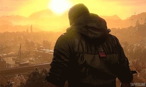a man in a black jacket is standing in front of a sunset with taffering written on the bottom right