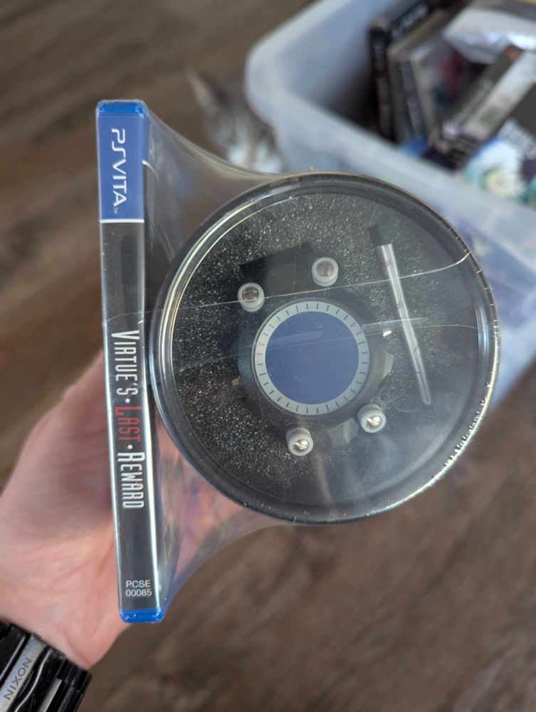A factory sealed Limited Edition copy of Zero Escape: Virtues Last Reward for the PlayStation Vita, complete with a bonus watch and tin to hold the watch.