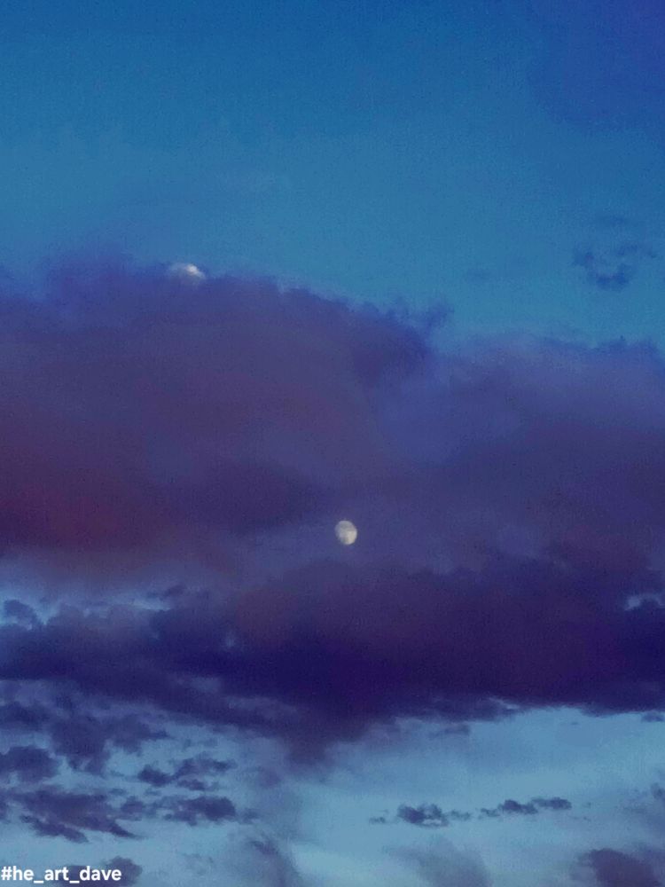 Blue toned cloud obscuring the moon.