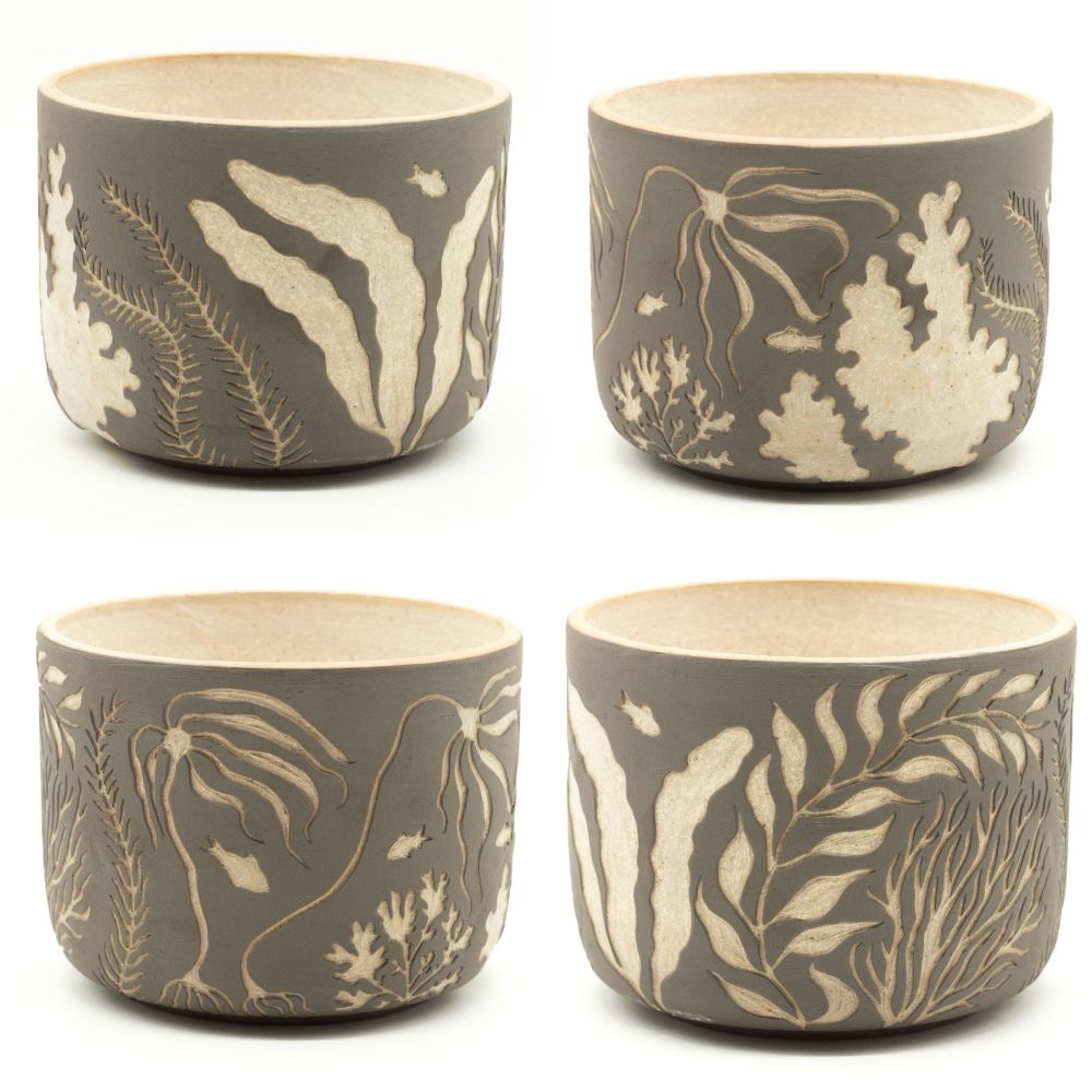 Ceramic planter carved with designs of seaweed and small fish