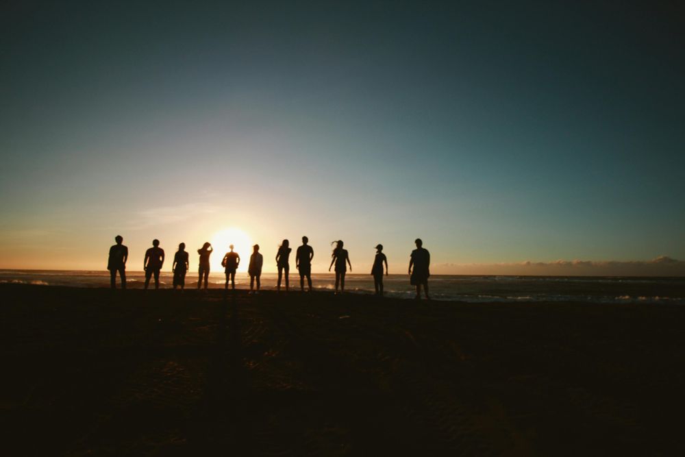 Silhouette of people at beach during sunset
