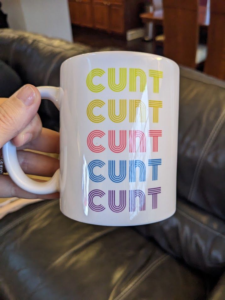 Coffee mug with the word "cunt" listed 5 times in different colors. Very disco vibe.