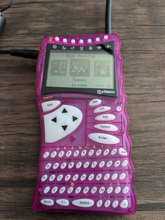 a clear pink cybiko internet communicator from the early 2000s