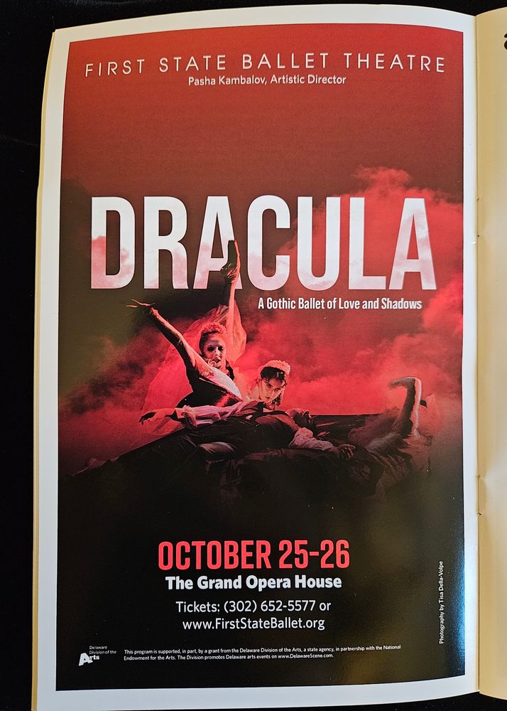 Theatre program for the Dracula ballet, featuring a swooning man with three women looming over him, set against a red background.