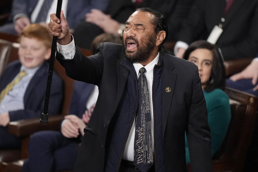 Rep. Al Green stands up shouting at Trump during Trump's address to Congress. 