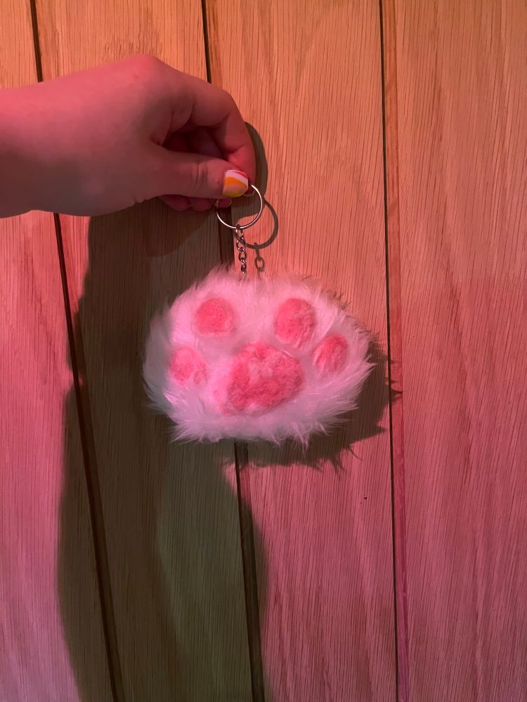 a white faux fur paw on a key ring 