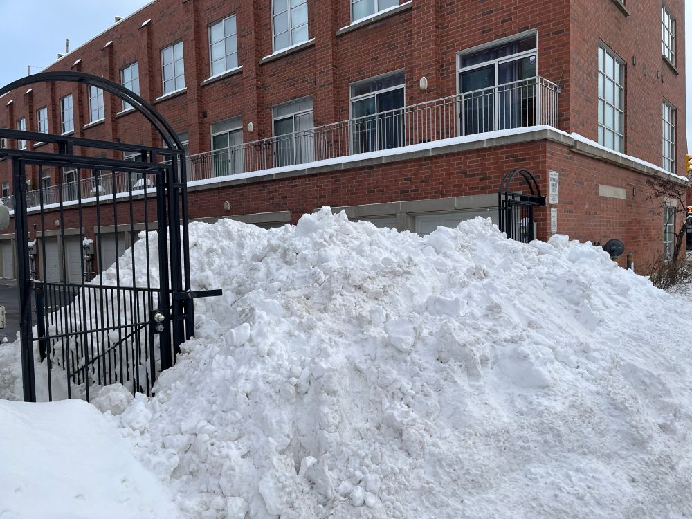 Big pile of snow in a condo driveway 