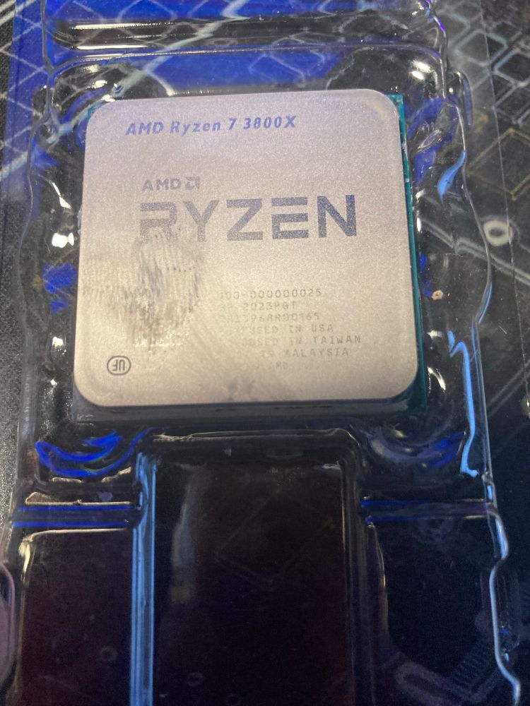 Ryzen 7 3800X CPU that still has some smears of thermal paste. 