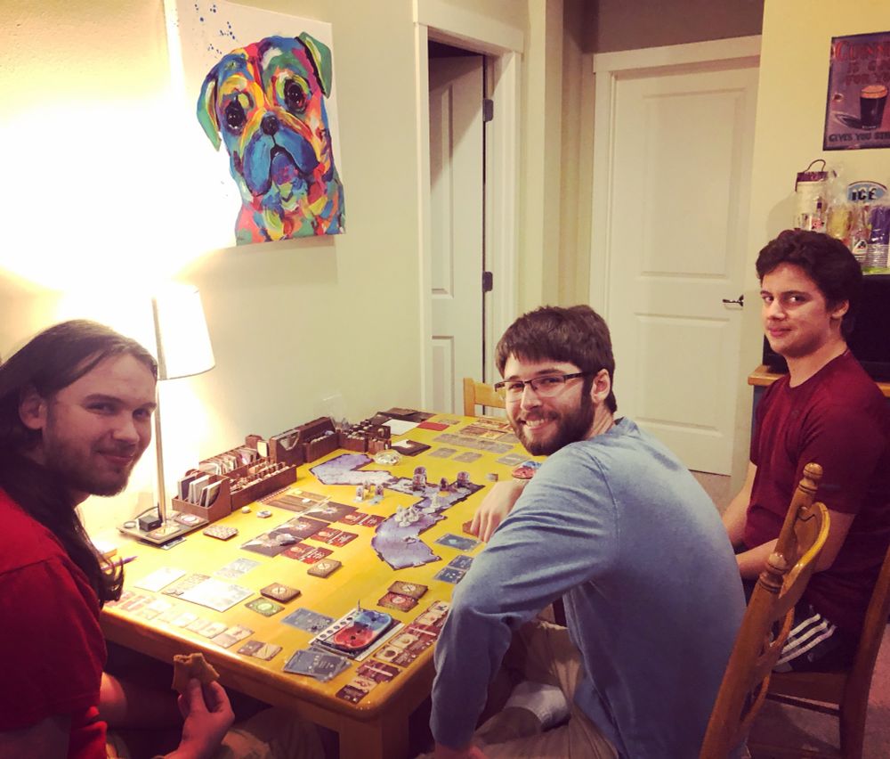 The boys, Gloomhaven, and the tie-died portrait of Ladybug. 