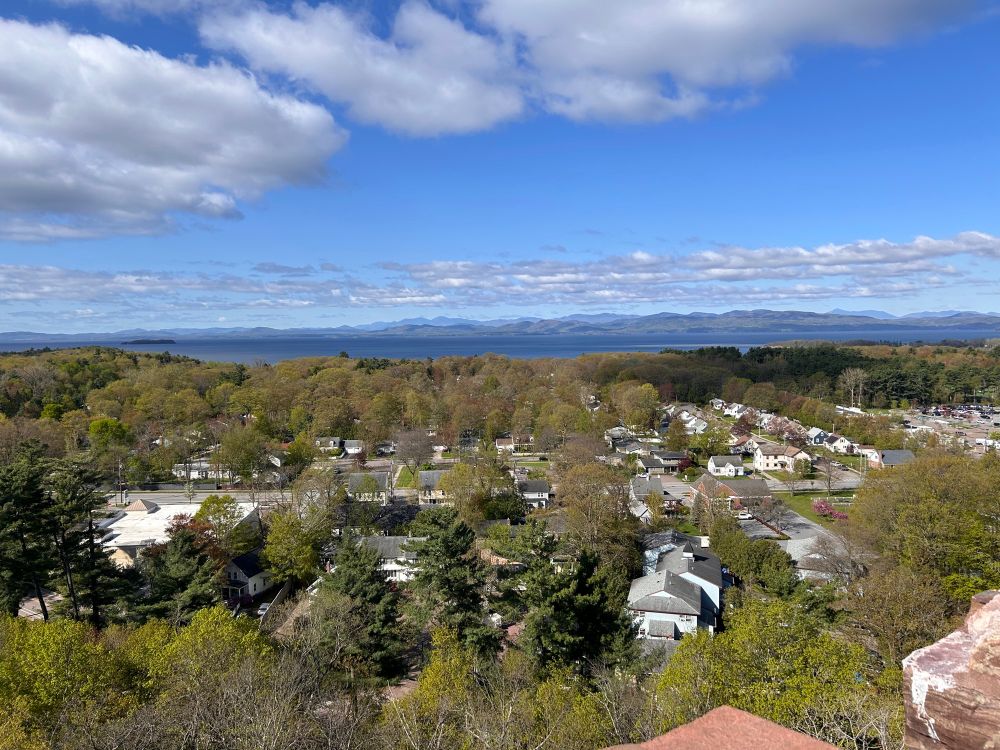 Photo from on top of a tower, showing a town from a bird’s-eye view. 