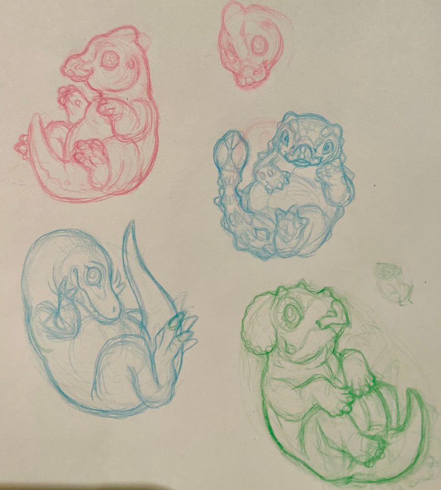 Sketchbook page with four baby dinosaurs. Top left is a parasaurolophus, top right is an ankylosaurus, bottom left is a tyrannosaurus, bottom right is a triceratops 