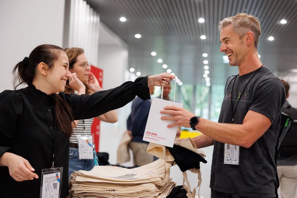 a woman handing a man a bag