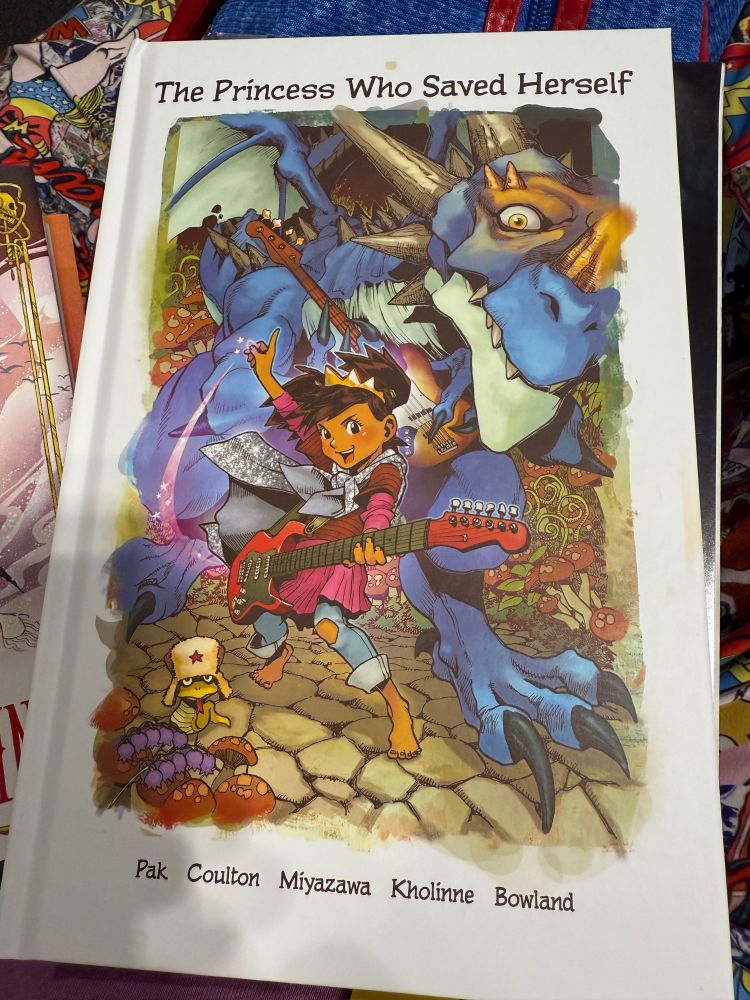 The Princess Who Saved Herself cover with a multi racial little girl playing guitar to a dragon 