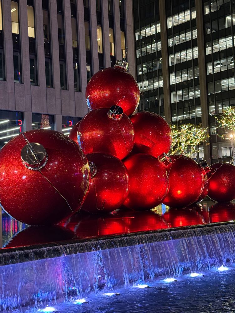 Huge red Christmas ball ornaments on display. 