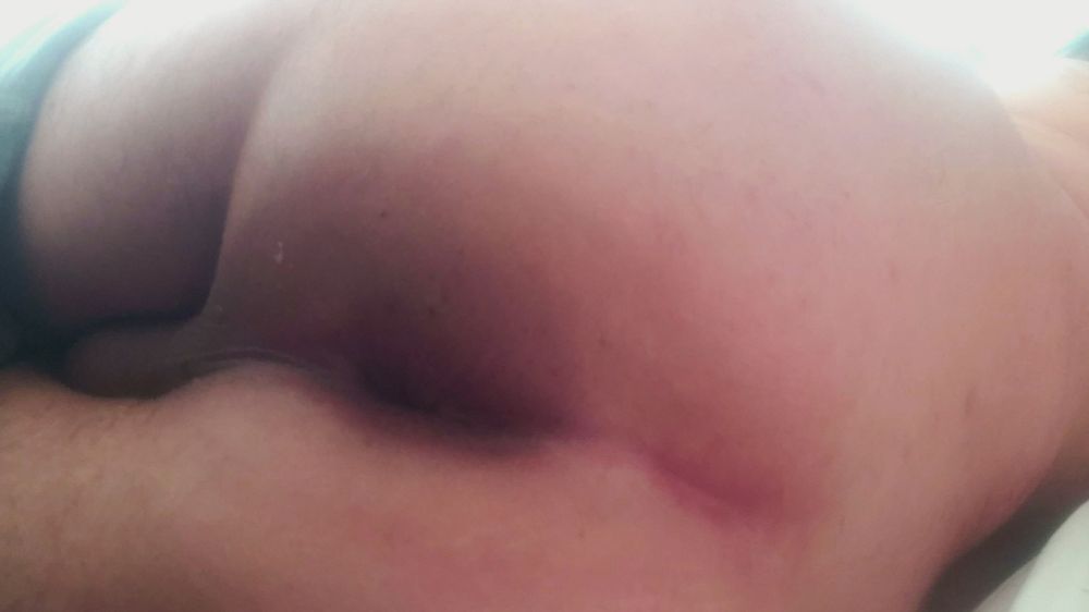 I am laying on my side, showing off my asshole.