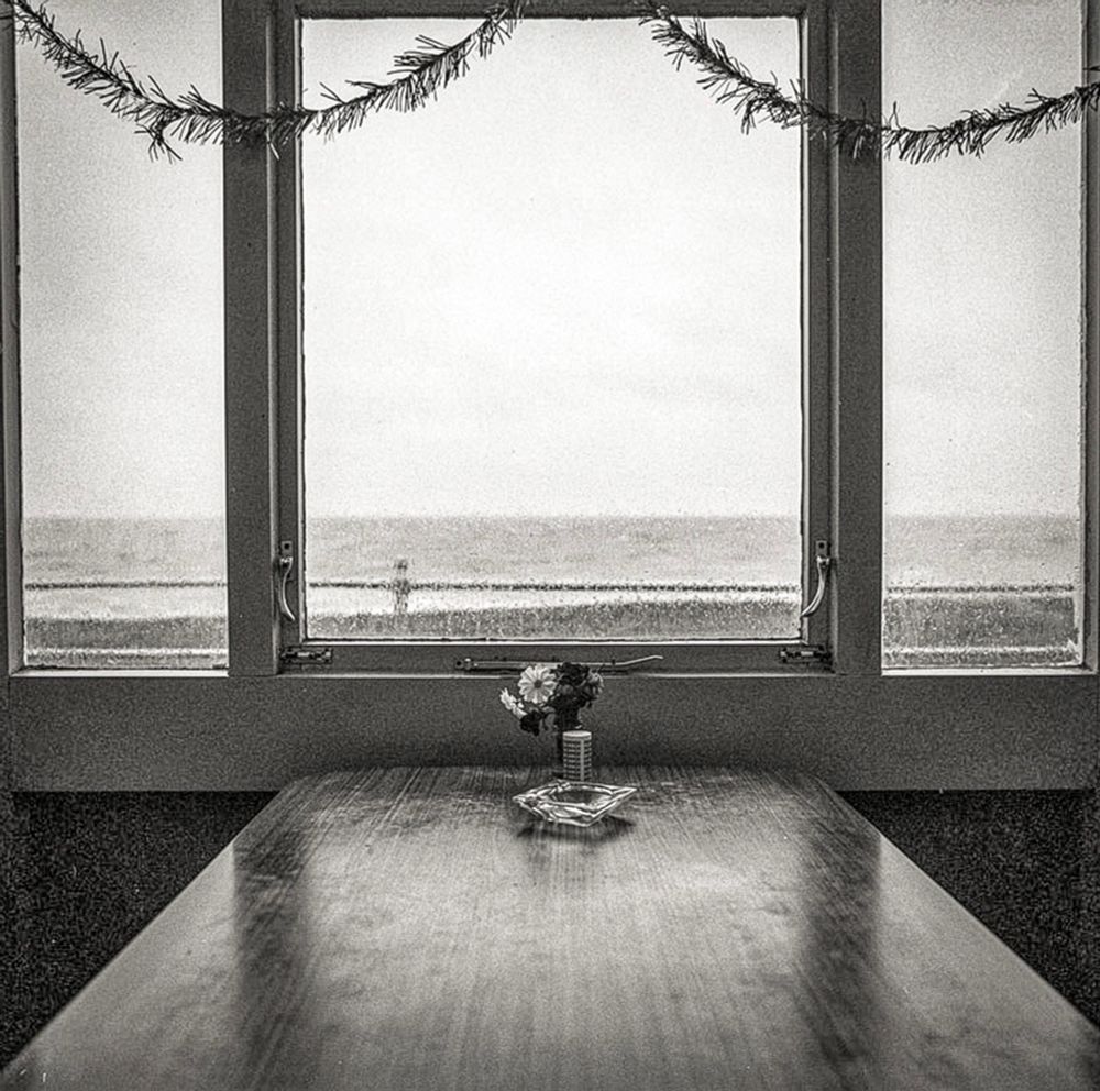 Boxing Day Bexhill-on-Sea
England 1996
I placed my tea on the worn formica table, watching the tinsel gently sway in the draughty air.       
It was Christmas 

#blackandwhitephotography
#filmphotography
#fineartphotography
#streetphotography
#seascapephotography
#bnwphoto
#blueskyphotography