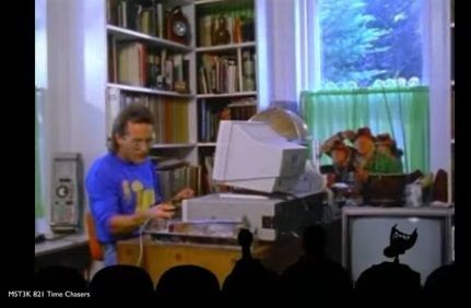 Nick works at his computer, not too far from a cardboard cutout of Michael J. Fox, Christopher Lloyd, and Mary Steenburgen as they appeared on the poster for Back to the Future Part III, as per MST3K's presentation of Time Chasers.

Servo, Mike, and Crow sit watching in silhouetted theater seats.