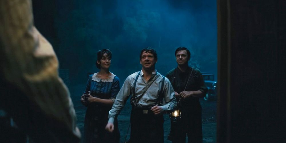 Screenshot from Sinners (dir. Ryan Coogler 2025). Remick and two other vampires stand outside the juke joint, trying to convince Cornbread to let them in. 