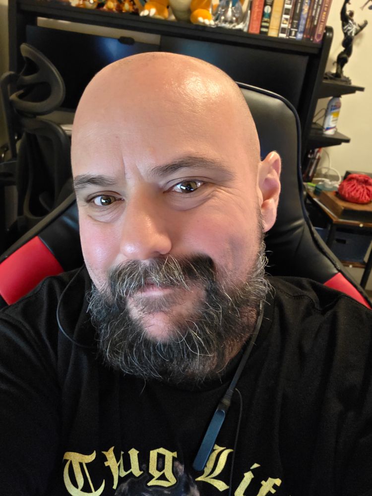 Nick in a golden girls t shirt smiles at the camera.