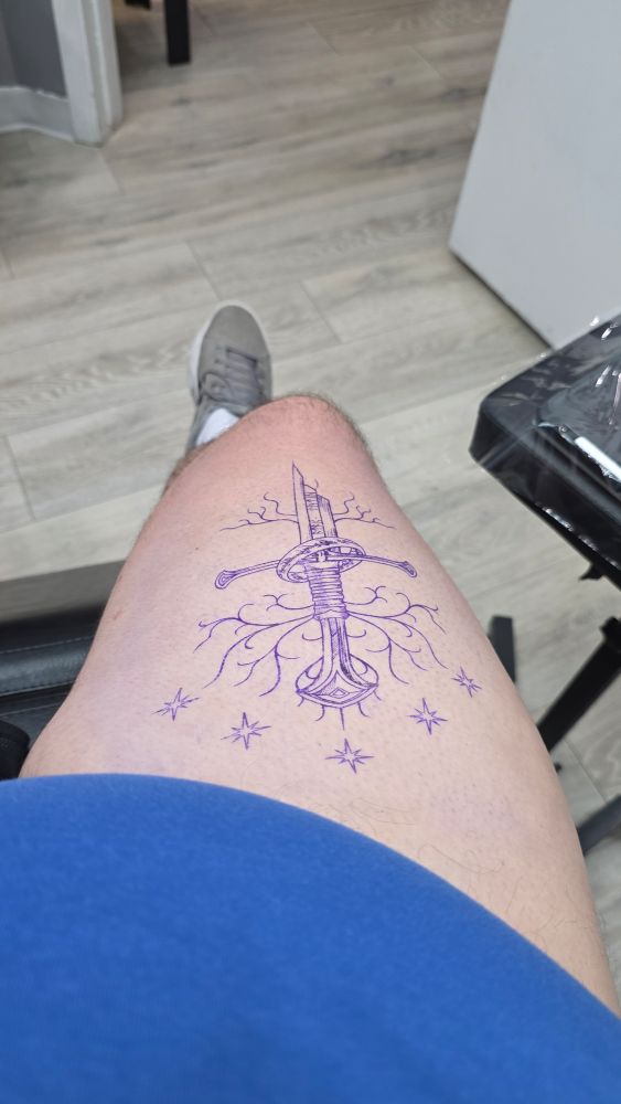 Nick's thigh with a tattoo stencil on it