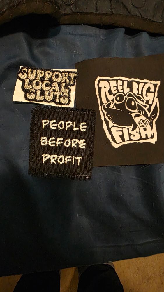 Patches that read "Support Local Sluts" "People before Profit" and "Reel Big Fish"