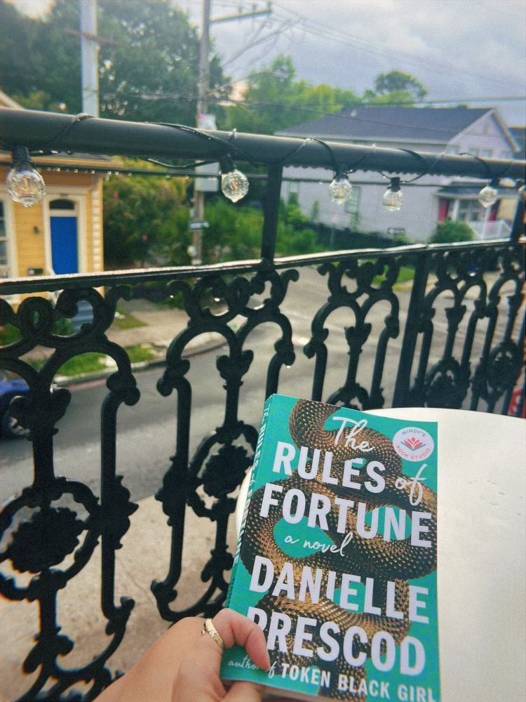 Currently Reading : The Rules of Fortune by Danielle Prescod on a balcony after the rain 