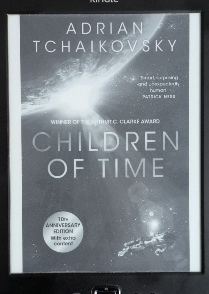 Kindle ebook cover of 'Children of Time' by Adrian Tchaikovsky, featuring a spaceship in the bottom right and a sun spreading light from below the edge of a planet.