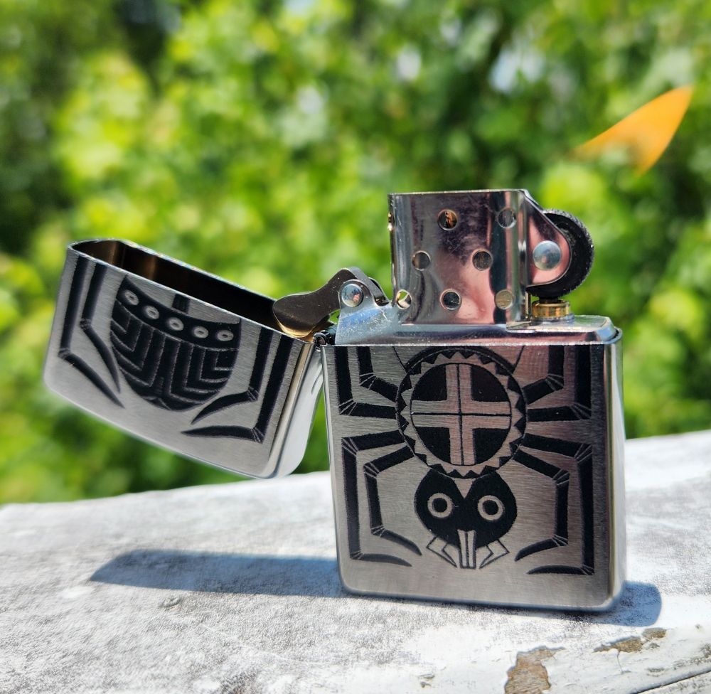 The same water spider lighter, open and lit.