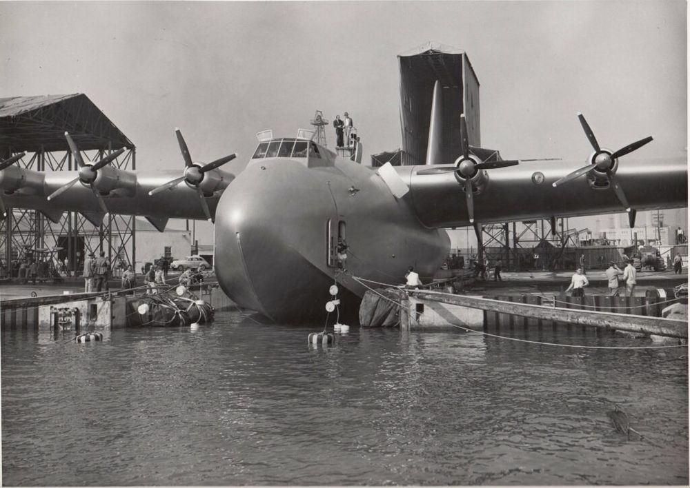 Black and white photo of The Spruce Goose docked.