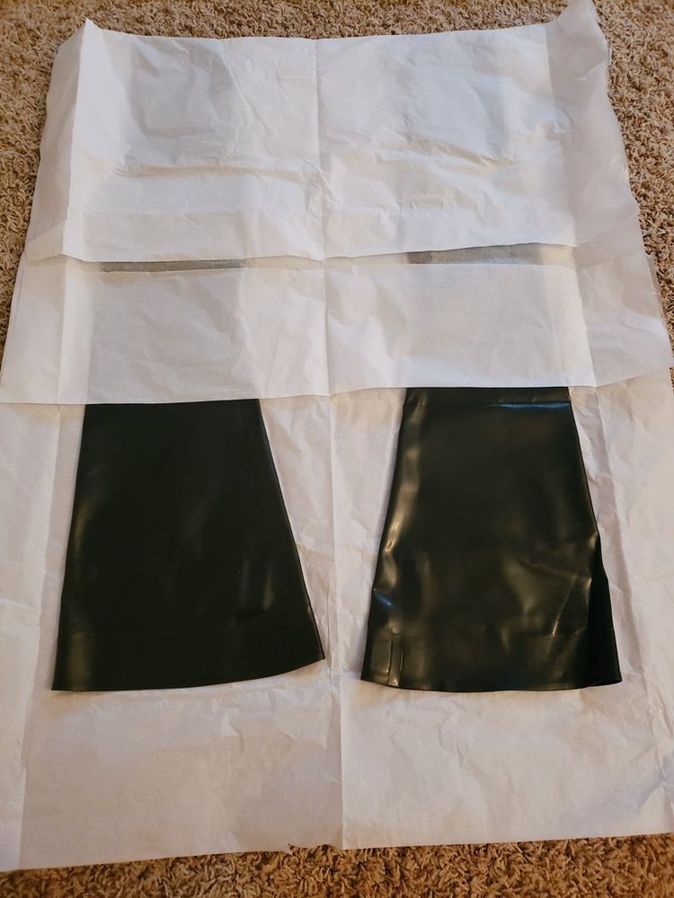 Picture of two latex stirrup stockings in paper storage covering