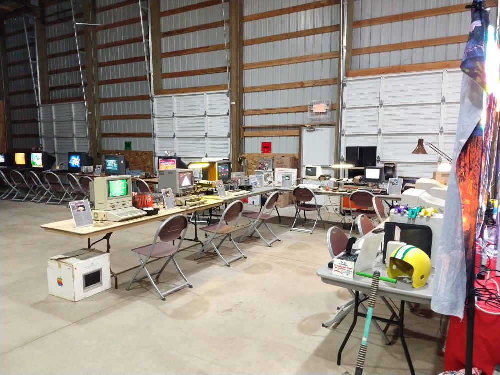 A collection of vintage home computers including an Apple II, Atari 800, and Vic-20
