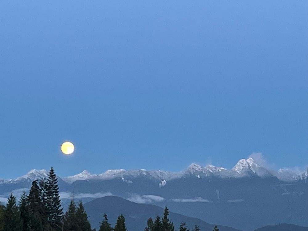 The full moon rises over the mountains north of Vancouver, apparently called a “beaver moon”. 