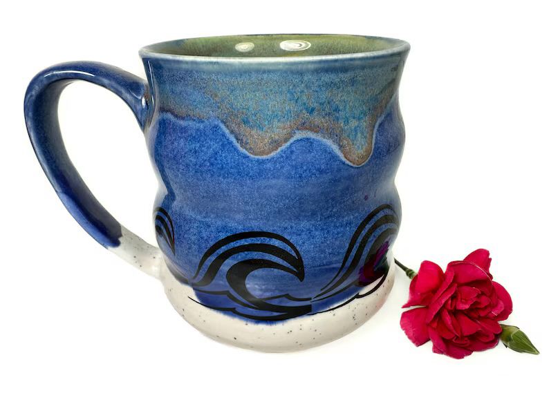 A hand painted stoneware mug with an ocean theme. 