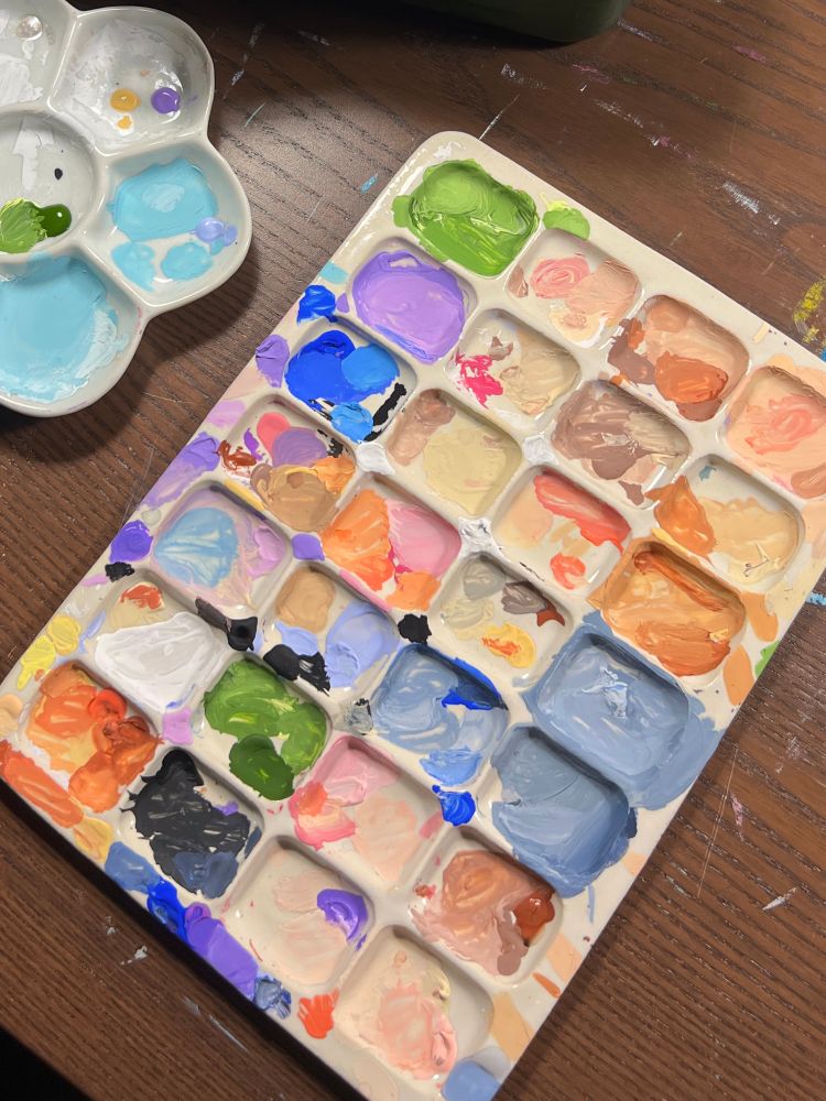 A messy colourful paint palette