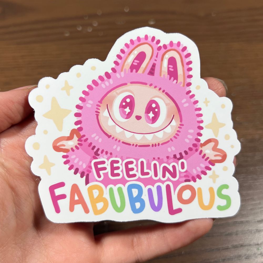 A cartoon of a pink Labubu with the text “feelin’ fabubulous”