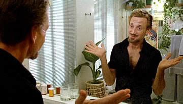 Joe Gideon, a middle aged Caucasian man played by Roy Scheider, looks at himself in the mirror after downing amphetamines to start his daily routine "it's showtime, folks!" in a still from bob Fosse's 1979 film ALL THAT JAZZ