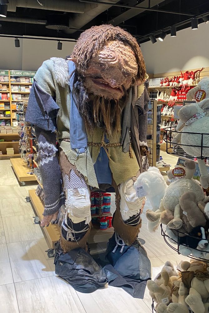 A large figure of a troll-like creature in a bookshop.