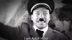 an image of a guy from the “Darth Vader vs Adolf Hitler” rap battle video saying “I am Adolf Hitler”. His eyes look fearful.