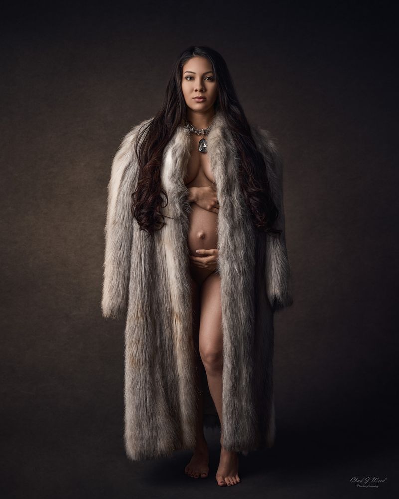 Fine art maternity portrait with fur coat