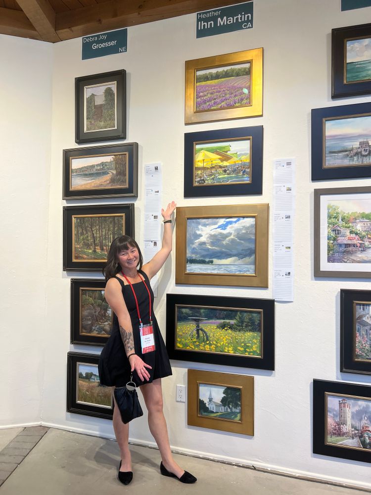 I am standing next to my artwork with open arms to display 